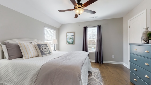 bedroom featuring dark wood-type flooring, multiple windows, ceiling fan, and vaulted ceiling