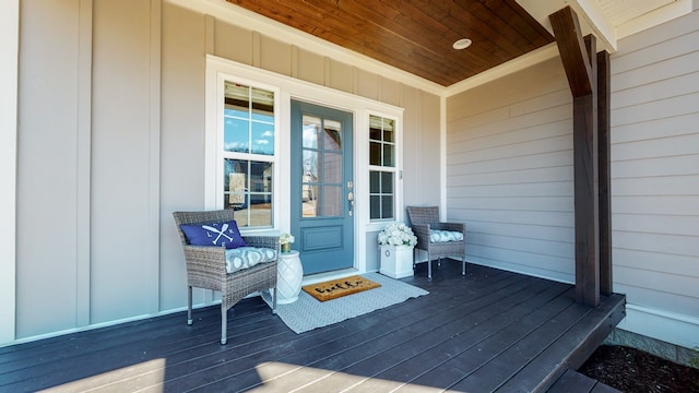 view of exterior entry with a wooden deck