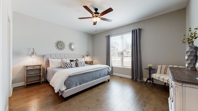 bedroom with dark hardwood / wood-style flooring and ceiling fan