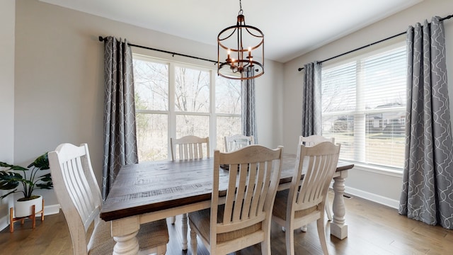 dining room featuring wood-type flooring and a chandelier