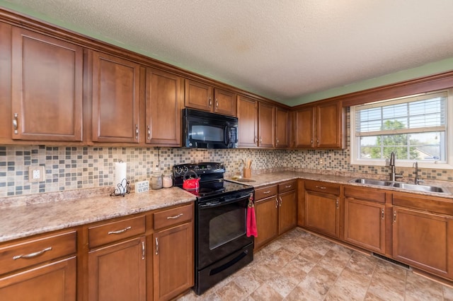 kitchen with decorative backsplash, black appliances, a textured ceiling, sink, and light stone countertops