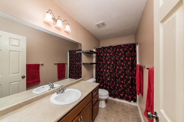 bathroom featuring toilet, vanity, and a textured ceiling