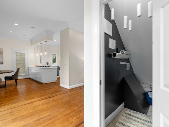 staircase with ornamental molding and hardwood / wood-style flooring