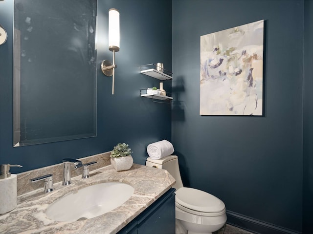 bathroom featuring toilet and vanity