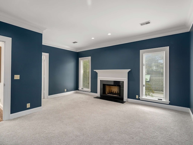 unfurnished living room with ornamental molding and light colored carpet