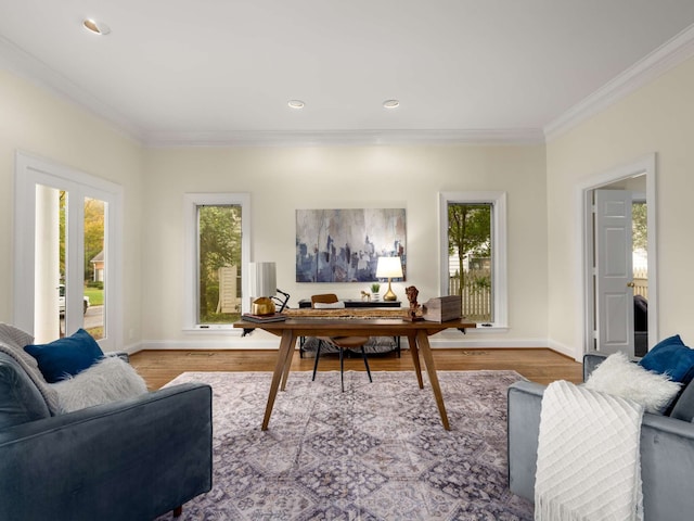 office area with light hardwood / wood-style flooring and ornamental molding