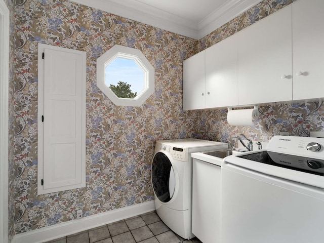 laundry area featuring ornamental molding, washer and clothes dryer, light tile patterned floors, cabinets, and sink