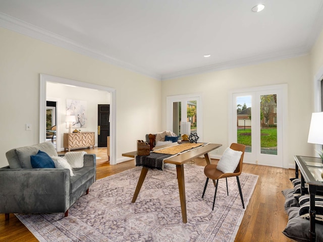 office space featuring french doors, light wood-type flooring, and crown molding