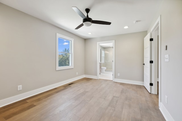 unfurnished bedroom featuring ensuite bathroom, light wood-type flooring, and ceiling fan