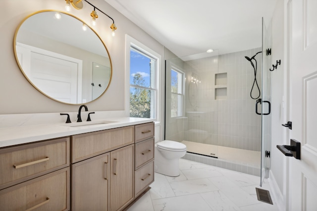 bathroom with walk in shower, vanity, and toilet