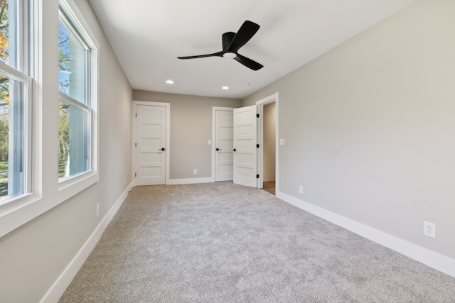 unfurnished bedroom featuring ceiling fan and carpet floors