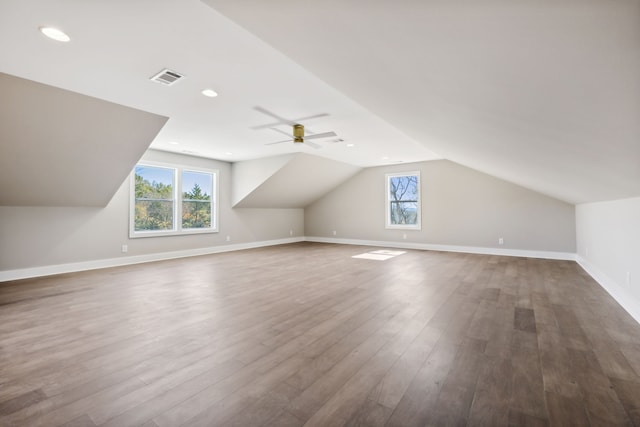 additional living space featuring hardwood / wood-style floors, lofted ceiling, and ceiling fan