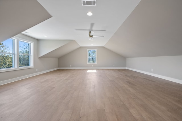 additional living space featuring light hardwood / wood-style floors, ceiling fan, plenty of natural light, and vaulted ceiling