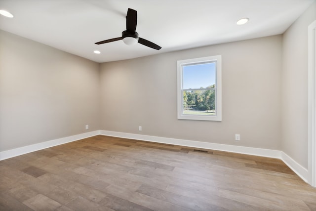 spare room with ceiling fan and light hardwood / wood-style flooring