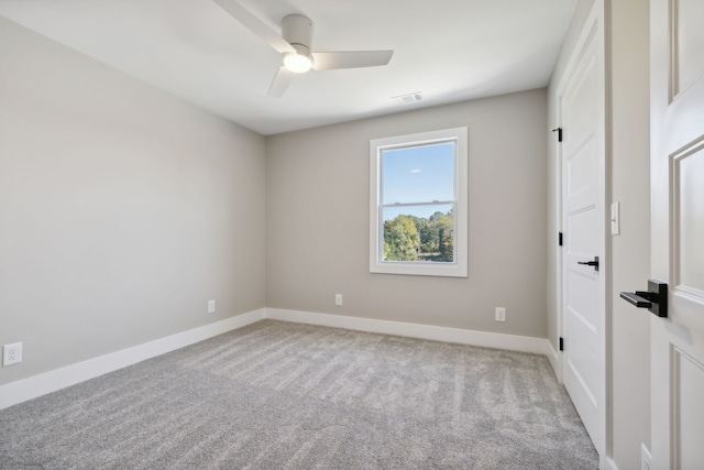 carpeted spare room with ceiling fan