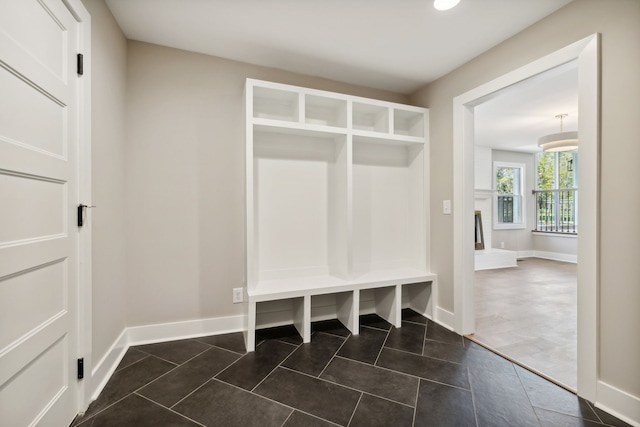 mudroom with dark tile patterned flooring