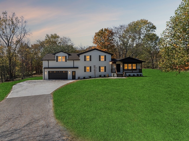 view of front of property featuring a lawn and a garage