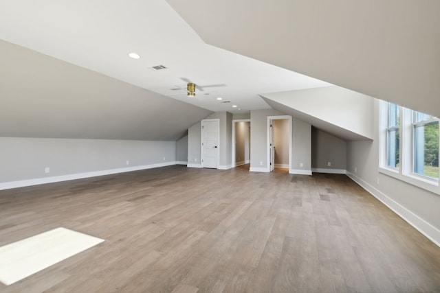 bonus room featuring light hardwood / wood-style floors, lofted ceiling, and ceiling fan