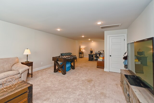 recreation room featuring light colored carpet