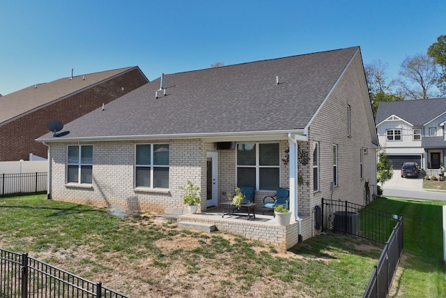 back of house featuring a patio and a yard