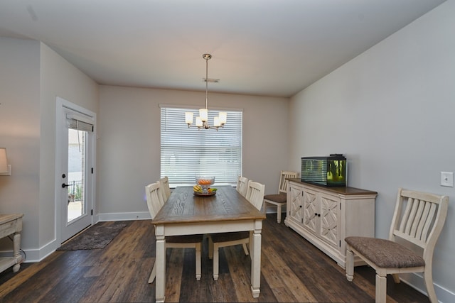 dining area with dark wood-type flooring and a chandelier