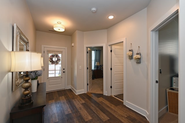 entryway with dark hardwood / wood-style flooring