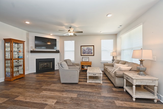 living room with ceiling fan, dark hardwood / wood-style floors, and a fireplace