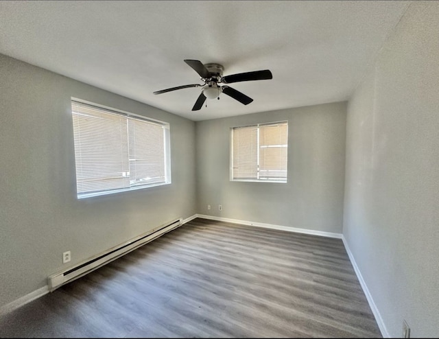 empty room with ceiling fan, dark hardwood / wood-style flooring, and a baseboard radiator