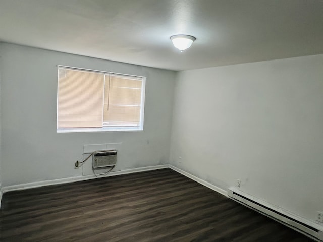 empty room featuring a baseboard radiator, an AC wall unit, and dark wood-type flooring