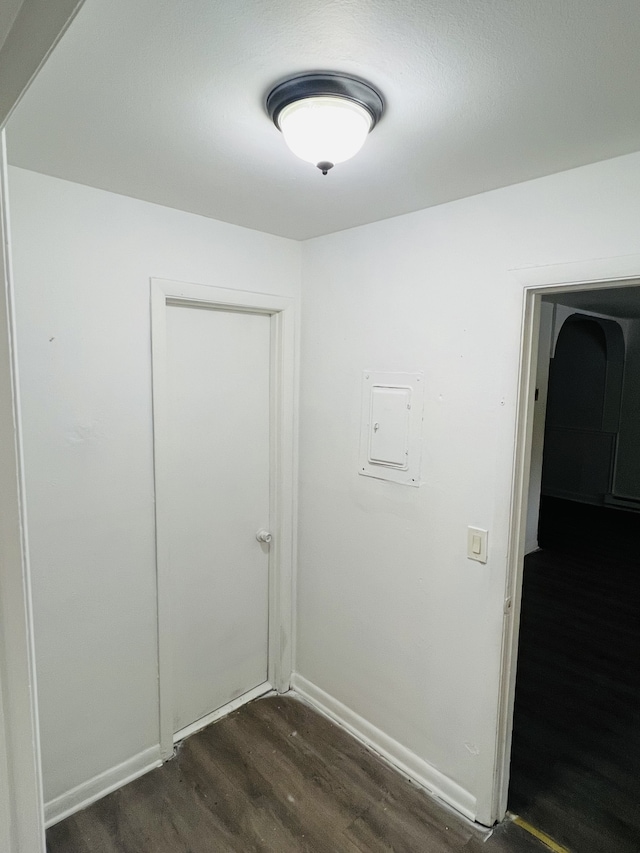 interior space with dark wood-type flooring and electric panel