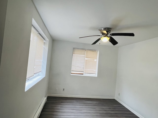 spare room with ceiling fan, plenty of natural light, and dark hardwood / wood-style floors