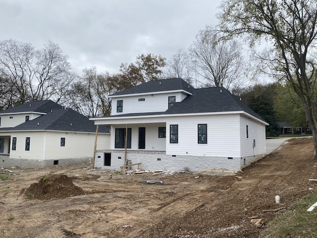 rear view of property featuring a porch