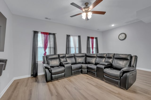 living room with wood-type flooring and ceiling fan