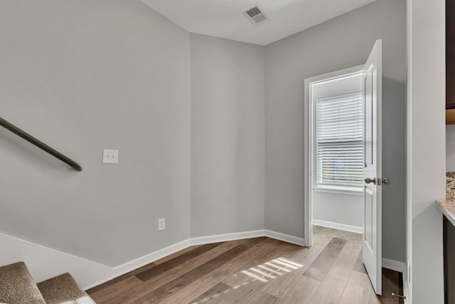 empty room with light hardwood / wood-style flooring