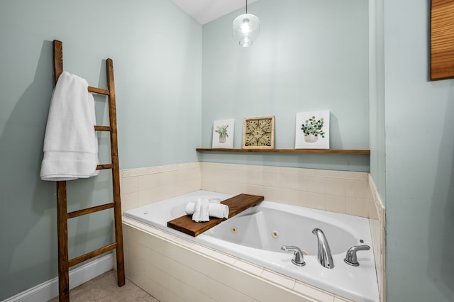 bathroom with tile patterned flooring and tiled tub