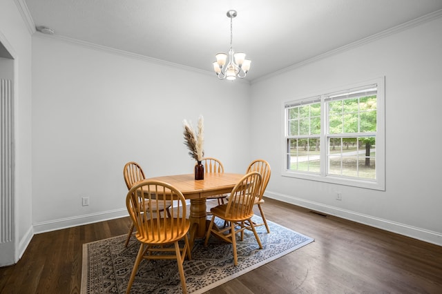 dining room featuring ornamental molding, dark wood-type flooring, and a notable chandelier