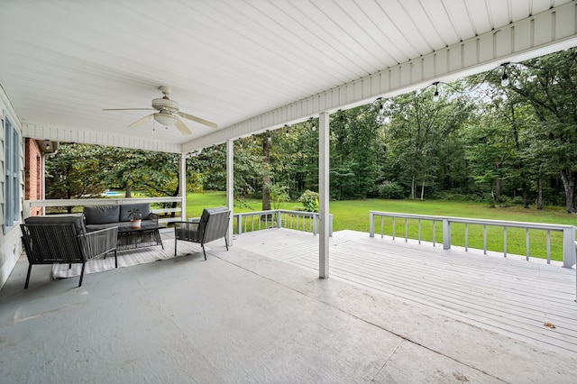 view of patio with ceiling fan, a wooden deck, and an outdoor living space