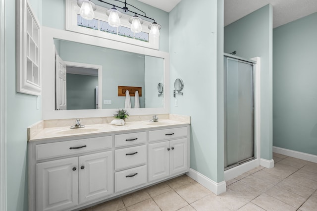 bathroom with vanity, tile patterned floors, an enclosed shower, and a textured ceiling