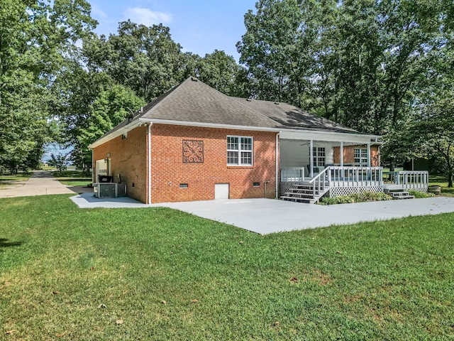 back of property with a patio, a lawn, and central air condition unit