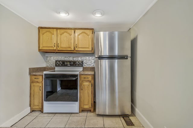 kitchen featuring stainless steel fridge, crown molding, backsplash, light tile patterned floors, and white electric range