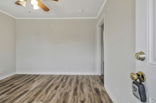 unfurnished room featuring dark wood-type flooring, ceiling fan, and crown molding