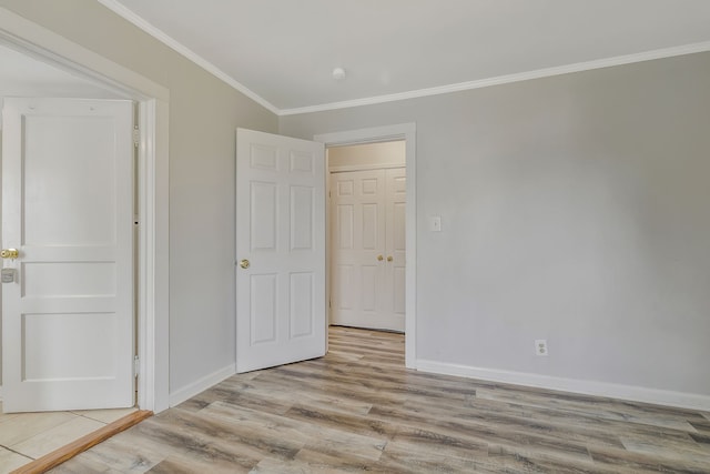 unfurnished bedroom featuring light wood-type flooring and crown molding