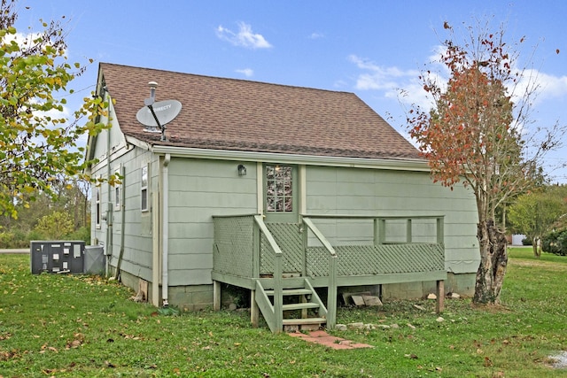 back of house with a lawn