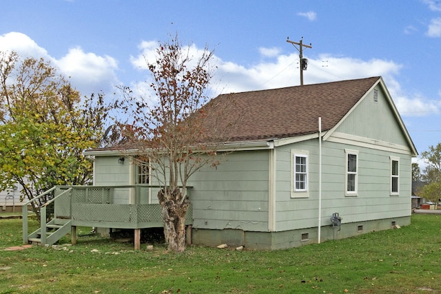 back of house with a wooden deck and a yard