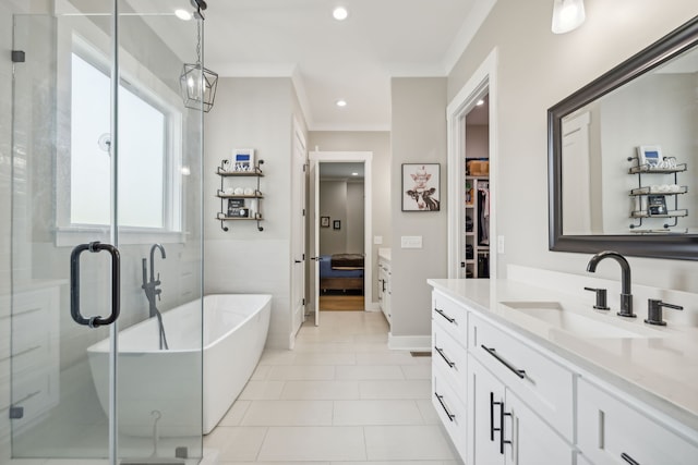 bathroom with ornamental molding, tile patterned flooring, shower with separate bathtub, and vanity