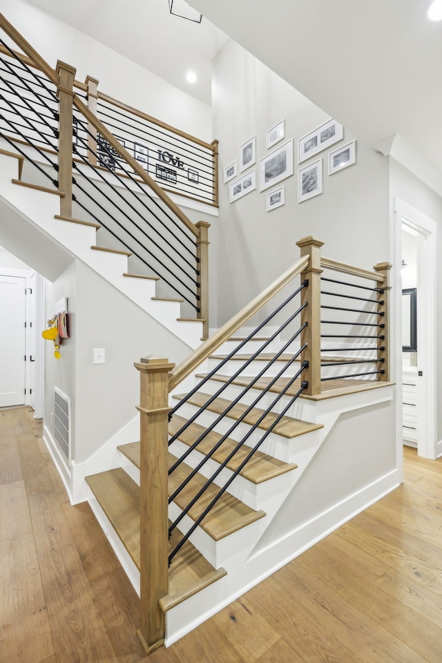 staircase with hardwood / wood-style flooring