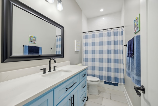 bathroom featuring vanity, tile patterned flooring, and toilet