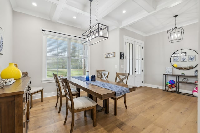 dining room featuring light hardwood / wood-style floors, beamed ceiling, a chandelier, crown molding, and coffered ceiling