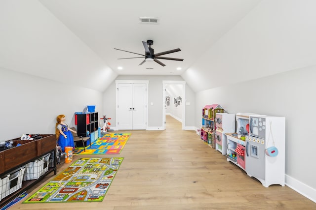 game room featuring ceiling fan, light hardwood / wood-style flooring, and vaulted ceiling