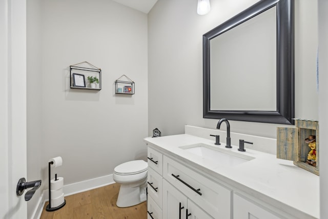 bathroom featuring hardwood / wood-style floors, vanity, and toilet